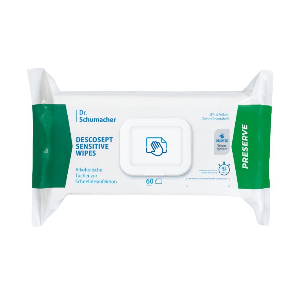 En förpackning med Dr. Schumacher Descosept Sensitive Wipes desinfektionsservetter från Dr. Schumacher GmbH för snabb desinfektion. Etiketten anger att det rör sig om alkoholbaserade servetter som är idealiska för medelstora ytor. Förpackningen är huvudsakligen vit med gröna detaljer och innehåller 60 servetter.