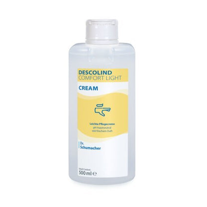 En 500 ml Dr. Schumacher GmbH DESCOLIND COMFORT LIGHT CREAM för känslig hud, med gul-vit etikett och blå handkrämsymbol.