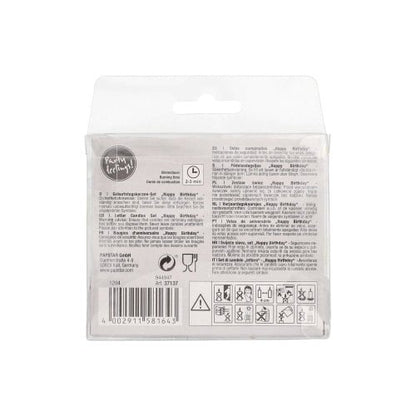 Baksidan av PAPSTAR bokstavsljusset pastell 8 cm "Happy Birthday" (12-pack) från PAPSTAR GmbH, med text, symboler och instruktioner på flera språk på en genomskinlig låda med streckkod och hanteringssymboler på botten.