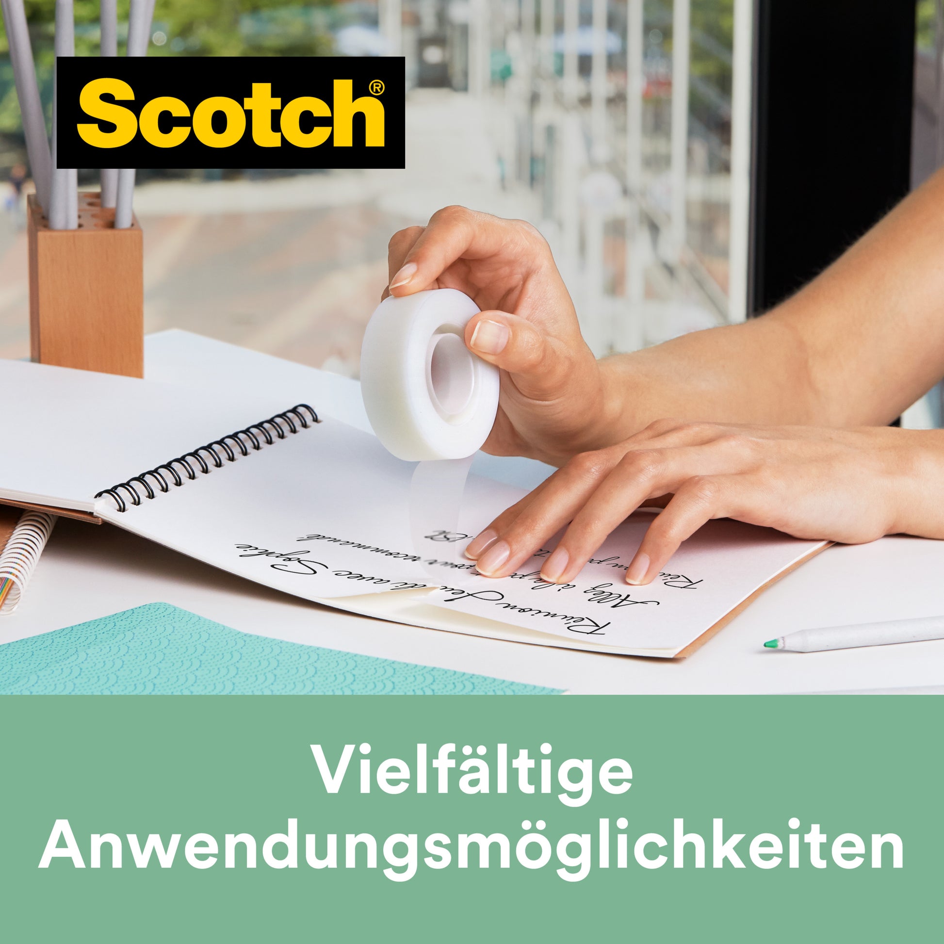 Eine Person benutzt Scotch® C38 Tischabroller schwarz mit Magic™ Klebeband (3 Rollen, 19 mm x 33 m, mit 66 % pflanzlichem Klebstoff) von 3M Deutschland GmbH, um Papier am Notizbuch zu befestigen. Text: "Vielfältige Anwendungsmöglichkeiten.