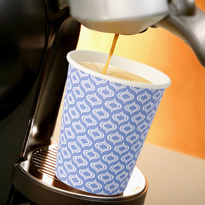 En Starpak 20 drickmugg "To Go" av återvinningsbar kartong (0,2 l, Ø 8–9,1 cm) med blå-vitt mönster står under pipen på en kaffemaskin som häller i färskt kaffe. Scenen är helvetiskt upplyst.