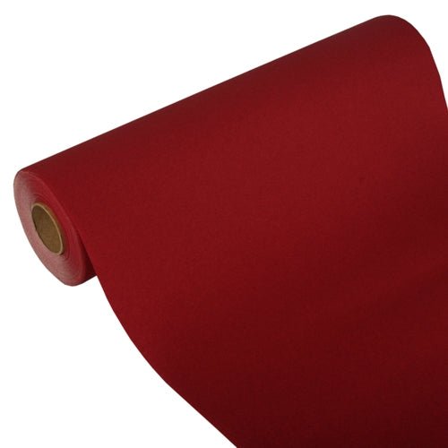 En delvis utrullad bordsduk från PAPSTAR GmbH, Tissue "ROYAL Collection" (24 m x 40 cm), visar sin kartongkärna mot en vit bakgrund och demonstrerar därmed sitt högkvalitativa tissue-material och sin eleganta design.