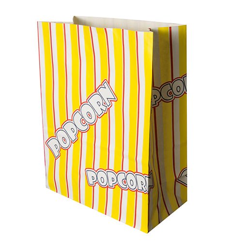 En rektangulär gul PAPSTAR popcornpåse (pergamentersättning, fettresistent) med röd-vita ränder och "POPCORN" i vit tryck från PAPSTAR GmbH står upprätt och verkar tom.