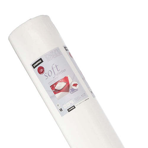 En rulle vit Starpak-bordsduk, tygliknande, fleece ”Soft Selection” (40 m x 0,9 m) avbildas upprätt i sin låda, med produktdetaljer och en bild av en bäddad säng på förpackningen mot en vit bakgrund.