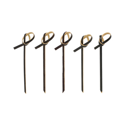 Fünf PAPSTAR 250 Fingerfood - Picker der PAPSTAR GmbH in Schwarz mit hellbraunen Schleifenakzenten an der Oberseite, in einer Reihe auf weißem Hintergrund angeordnet.