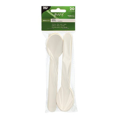 I en genomskinlig förpackning från PAPSTAR GmbH finns 20 vita, miljövänliga pappersskedar ("pure", 15,5 cm), prydligt staplade och väl synliga bakom en grön-vit toppetikett med produktinformation.