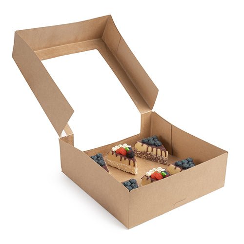 De PAPSTAR 25 tårtkartonger med lock fyrkantig med fönster av PLA från PAPSTAR GmbH innehåller fyra dekorerade tårtbitar med grädde och olika frukter, vackert presenterade i den miljövänliga förpackningen.