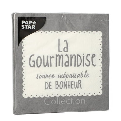 Ett grått PAPSTAR GmbH 20 servettförpackning (33x33 cm, 3-lagers, 1/4-vikt) är försedd med en vit spetskant, den franska texten "La Gourmandise source inépuisable de bonheur" och PAP*STAR-logotypen i vitt på svart i det övre vänstra hörnet.