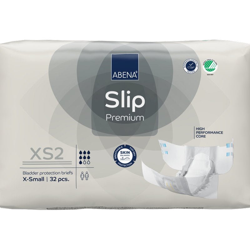 Ett 32-pack ABENA Slip Premium från Abena Re-Seller GmbH i storlek XS2 X-Small i beige förpackning med certifieringarna "High Performance Core" och "Skin Friendly" för pålitlig inkontinensvård.