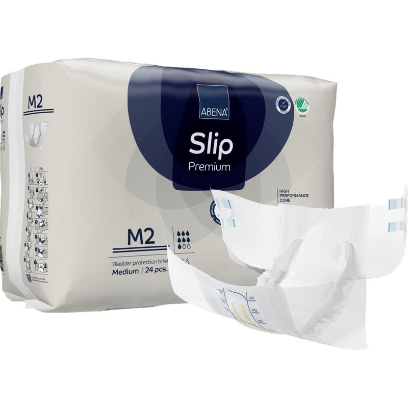 Bakom ett utfällt skydd är ett paket ABENA Slip Premium från Abena Re-Seller GmbH, storlek M2, avbildat. På förpackningen anges att den innehåller 24 medelstora skydd för pålitlig inkontinensvård.
