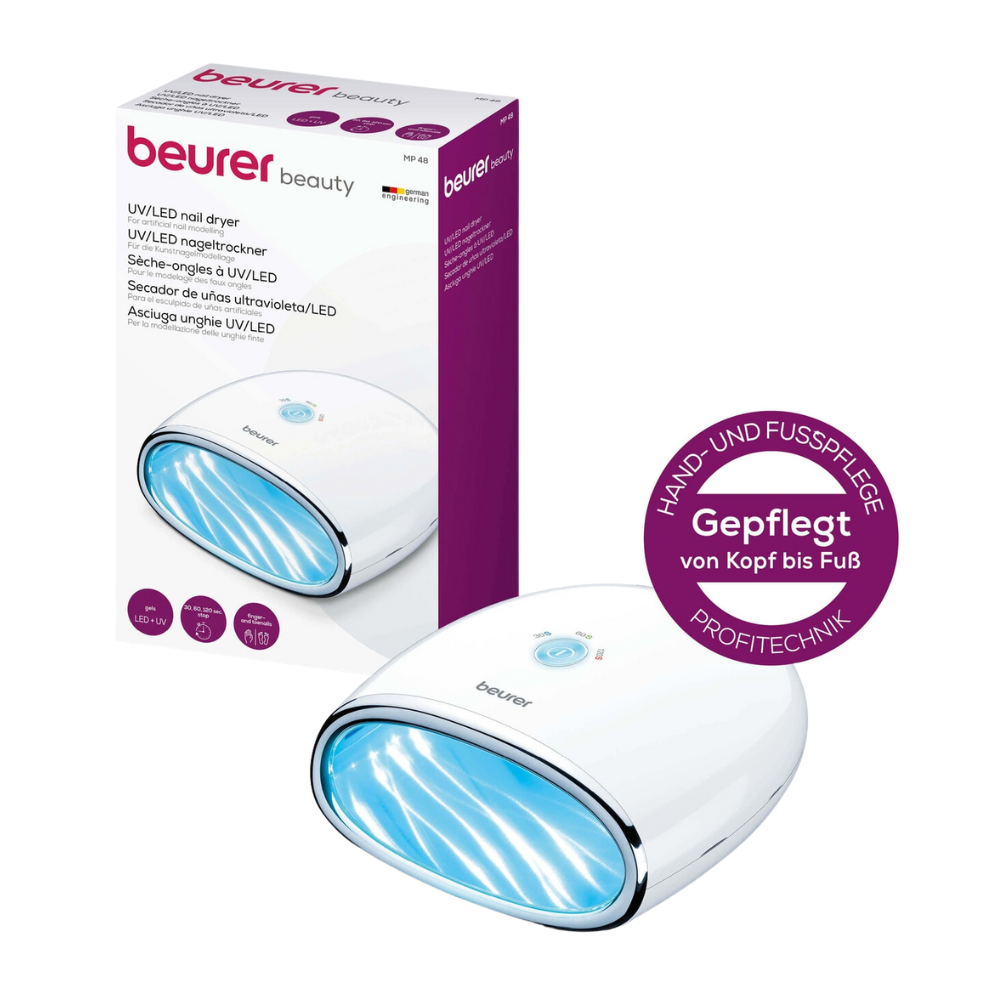 Utgångsartikeln Beurer MP 48 LED/UV-nageltorkare från Beurer GmbH står bredvid sin förpackning. Nagellampan är lämplig för hand- och fotvård samt konstnagelmodellering. På lådan visas detaljer och varumärke på tyska.