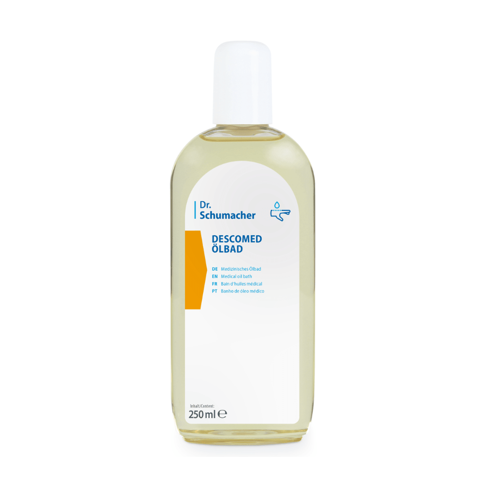 En klar plastflaska med vit kork innehåller Dr. Schumacher Descomed oljebad | Flaska (250 ml) från Dr. Schumacher GmbH. Den flerspråkiga etiketten ger information om produkt och mängd och är idealisk för vård av torr hud.
