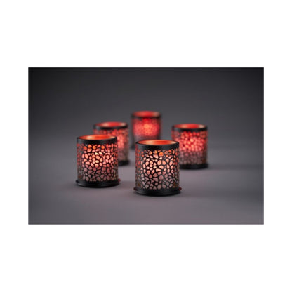 Åtta lysande Multicolour LED Set, Mini-ljus från Duni GmbH i mönstrade hållare kastar ett varmt, färgglatt ljus genom perforerade mönster på en mörk yta; den mjukt suddiga bakgrunden förstärker den mysiga stämningen.