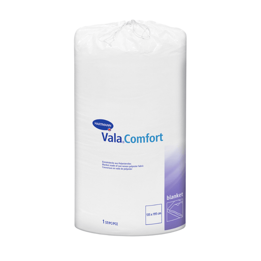 En förseglad vit rulle med Hartmann Vala®Comfort-täcken från Paul Hartmann AG, avbildad mot en vit bakgrund. Etiketten visar produktinformation och mått (155 x 210 cm).