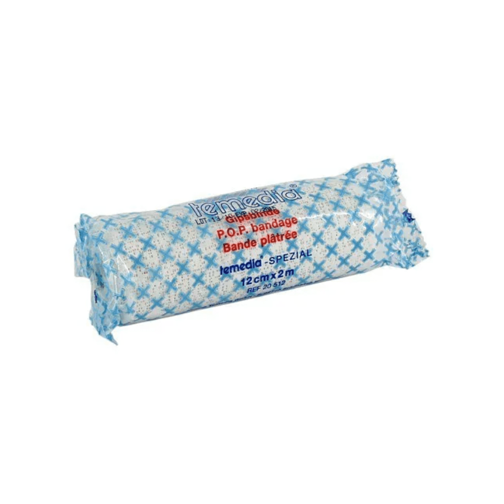 En rullad binda för immobilisering är förpackad i en blå-vit förpackning, bär texten ”Holthaus Temedia-Spezial Gipsbinde - 1 Binda” och ”Bande plâtrée” och mäter 12 cm x 2 m. På förpackningen är varumärket ”Holthaus Medical GmbH & Co. KG” tryckt, lämplig för immobilisering vid frakturer.