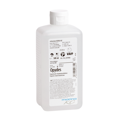 Vit 500-ml plastflaska Kiehl Opydes Hygienische Händedesinfektion från Johannes Kiehl KG med vit kork och etikett med användningsinstruktioner, doseringsinformation, tillverkarinformation och certifieringslogotyper.