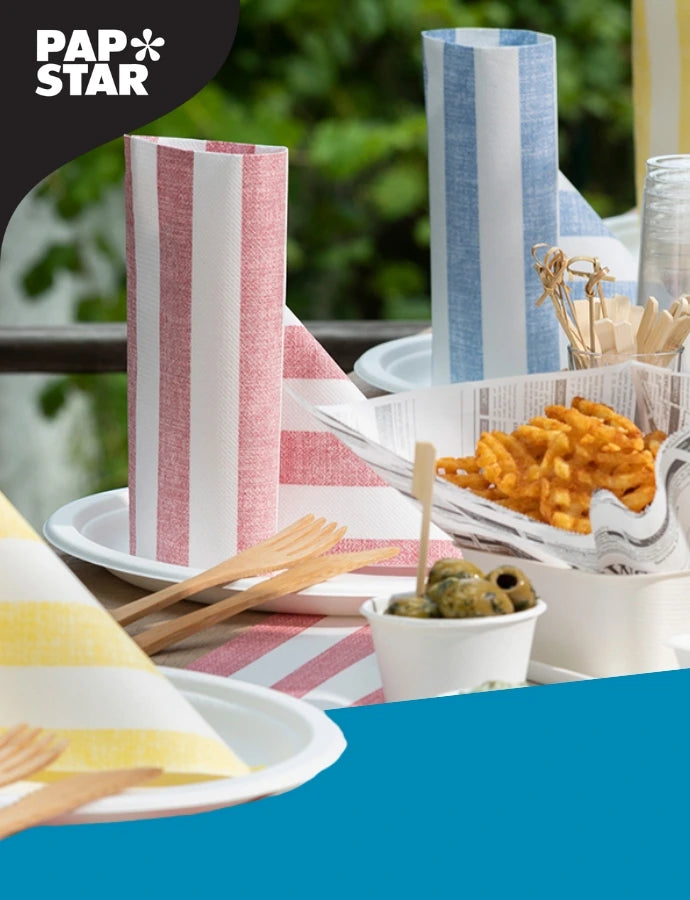 PAPSTAR Produktbild mit gestreiften Servietten, Einweggeschirr, Holz-Besteck und Snacks auf einem frühlingshaft gedeckten Tisch.