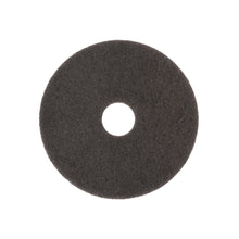 Arcora SUPERPAD MÖRKBRUN från Arcora International GmbH är en rund, platt, svart skrubbsvamp med ett hål i mitten och grov struktur, idealisk för polering av mörka ytor med polermaskinen. Avbildad mot vit bakgrund.