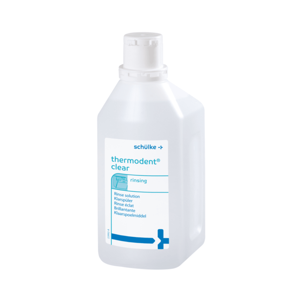 På en blå-vit plastflaska med texten „Schülke Thermosept BSK- 1 Liter“ är texten „Klarspüler“ för tandhygien markerad. Etiketten från Schülke & Mayr GmbH påpekar lämpligheten för tandläkarinstrument och har en säker skruvlock.