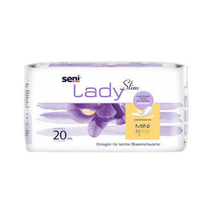 En 20-pack Seni Lady Slim Mini a20 från TZMO Deutschland GmbH med violett irisdesign och tysk text erbjuder lätt skydd vid urinläckage med Extra Dry System för andningsförmåga och absorptionsförmåga.
