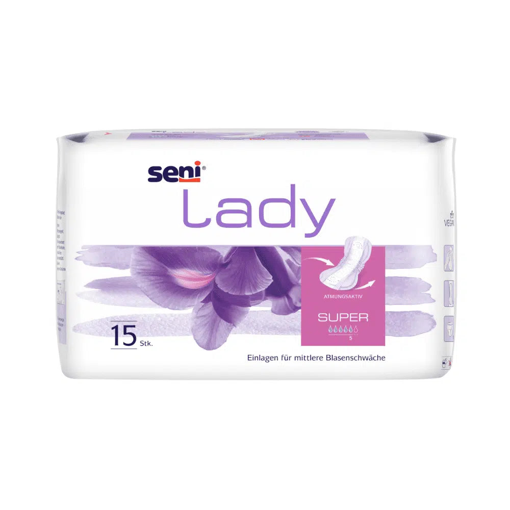 Seni Lady Super inkontinensskydd från TZMO Deutschland GmbH är en vit förpackning med violetta accenter och blommotiv och innehåller 15 inlägg för medelstark blåssvaghet. Den tyska texten innehåller information om bärkomfort, egenskaper och absorptionsförmåga.