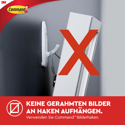 Ein Foto zeigt ein gerahmtes Bild, das an einem Wandhaken mit einem großen roten X hängt. Der deutsche Text rät von der Verwendung von Haken ab und empfiehlt stattdessen 3M Deutschland GmbH Command™ Small Drahthaken, 17067 oder andere selbstklebende Haken.