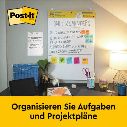 Ein Schreibtisch mit Büromaterialien, einer Lampe und einer Tafel mit der Aufschrift "Daily Reminders" auf dem Post-it® Super Sticky selbsthaftendes Mini Meeting Chart 577SS der 3M Deutschland GmbH. Das Post-it Markenlogo erscheint oben links, über einem deutschen Text über die Organisation von Aufgaben und Plänen.
